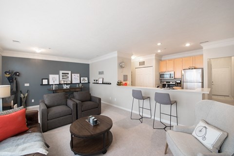 a living room with a kitchen and a couch and a table